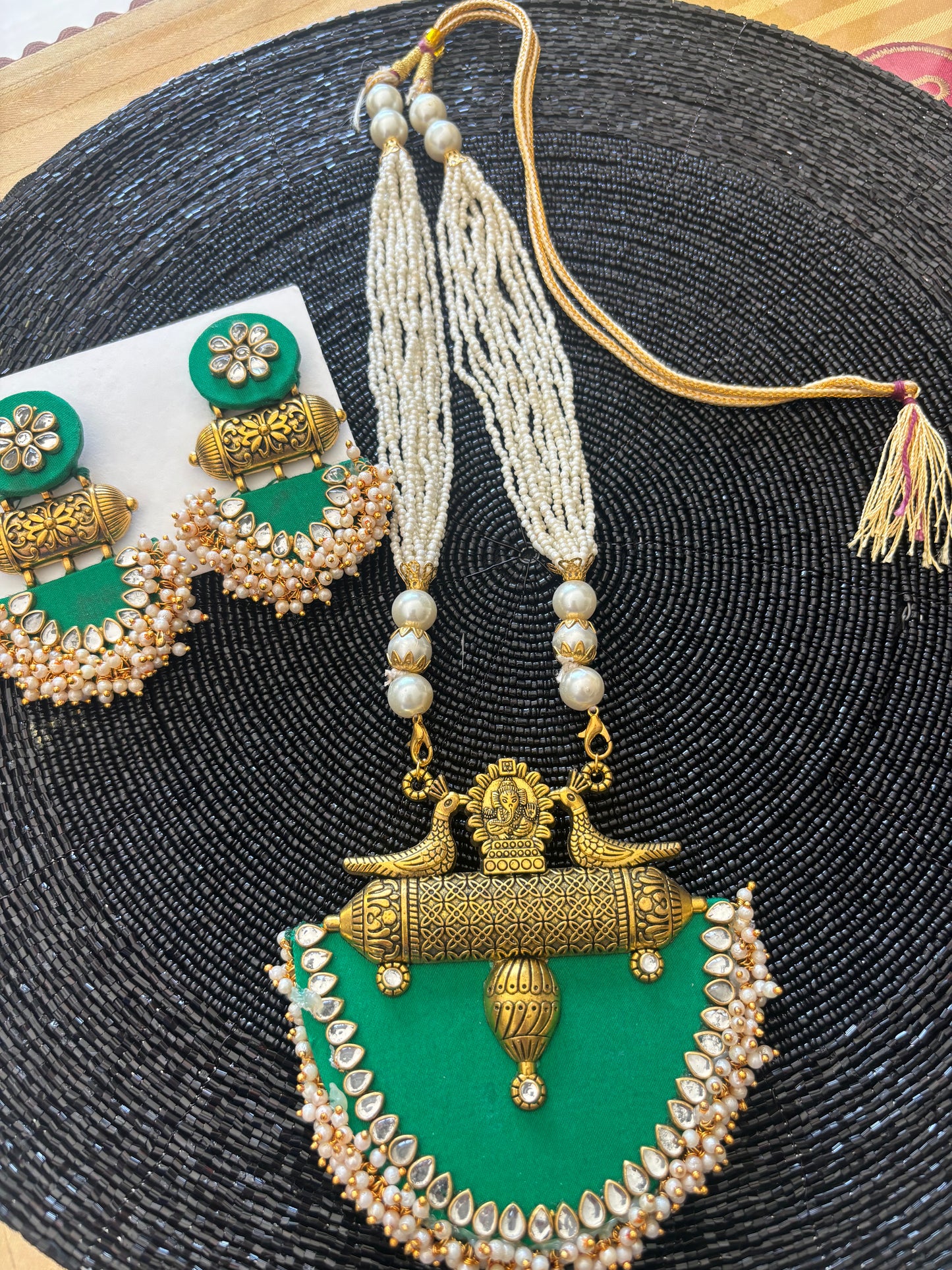 Long fabric necklace completed with faux beads and matching earrings - green