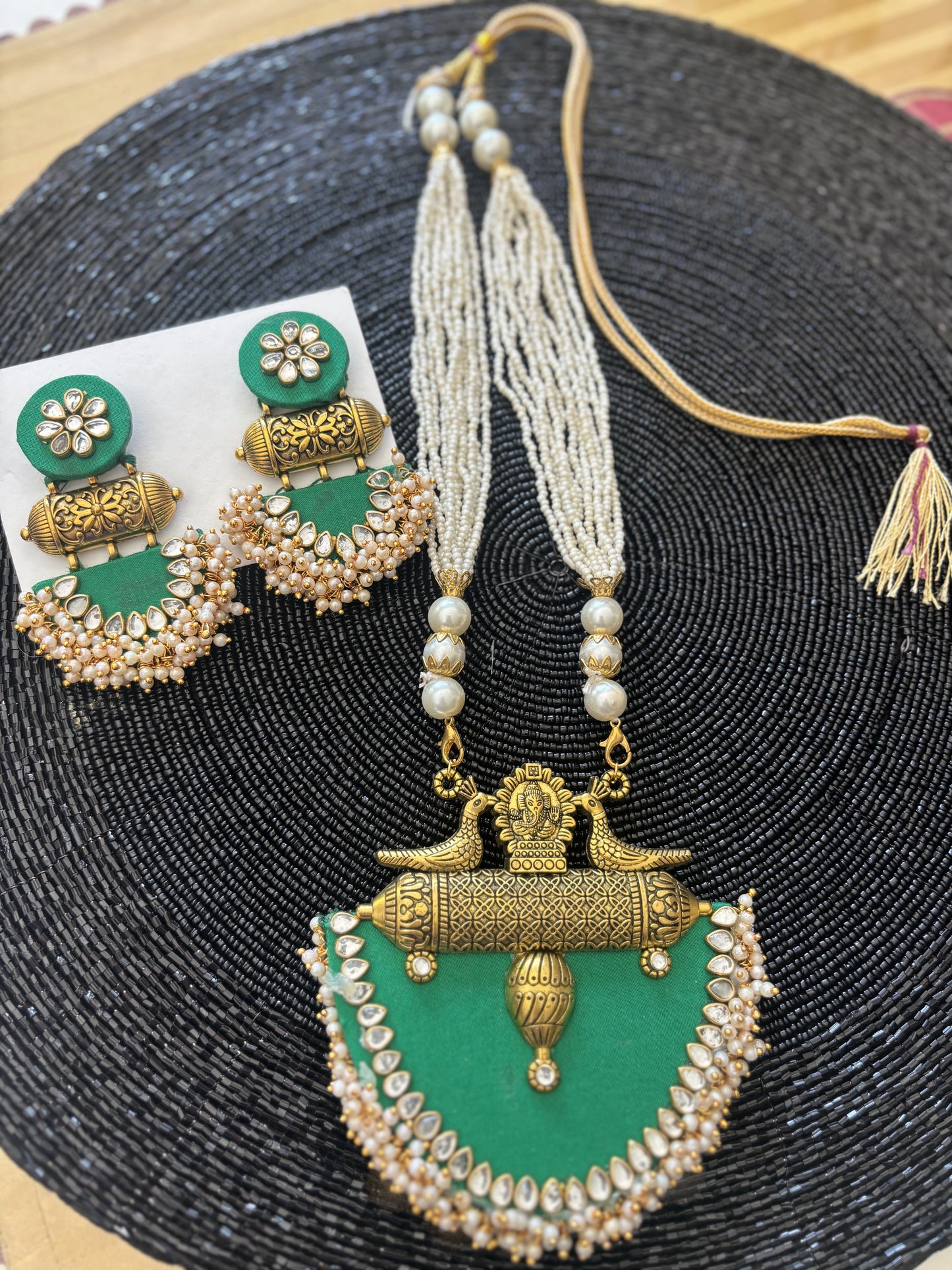 Long fabric necklace completed with faux beads and matching earrings - green