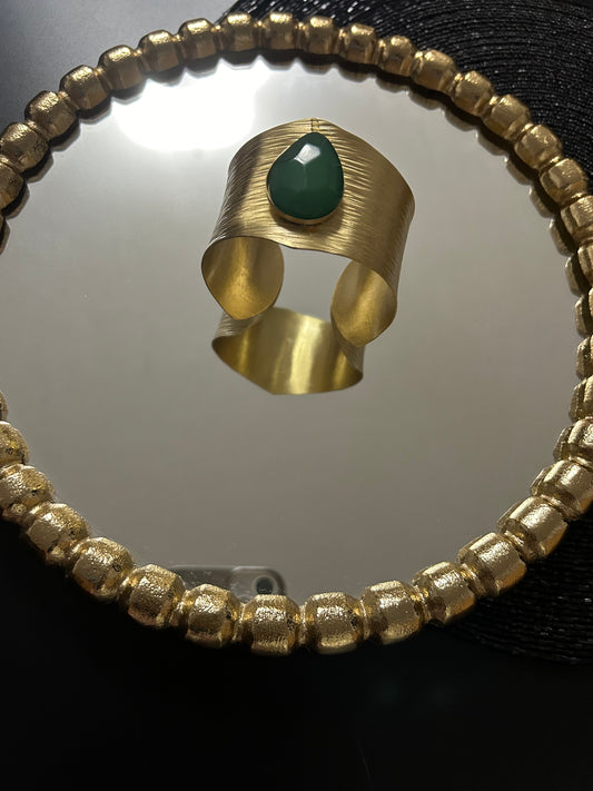 Brass bracelet with green faux stones