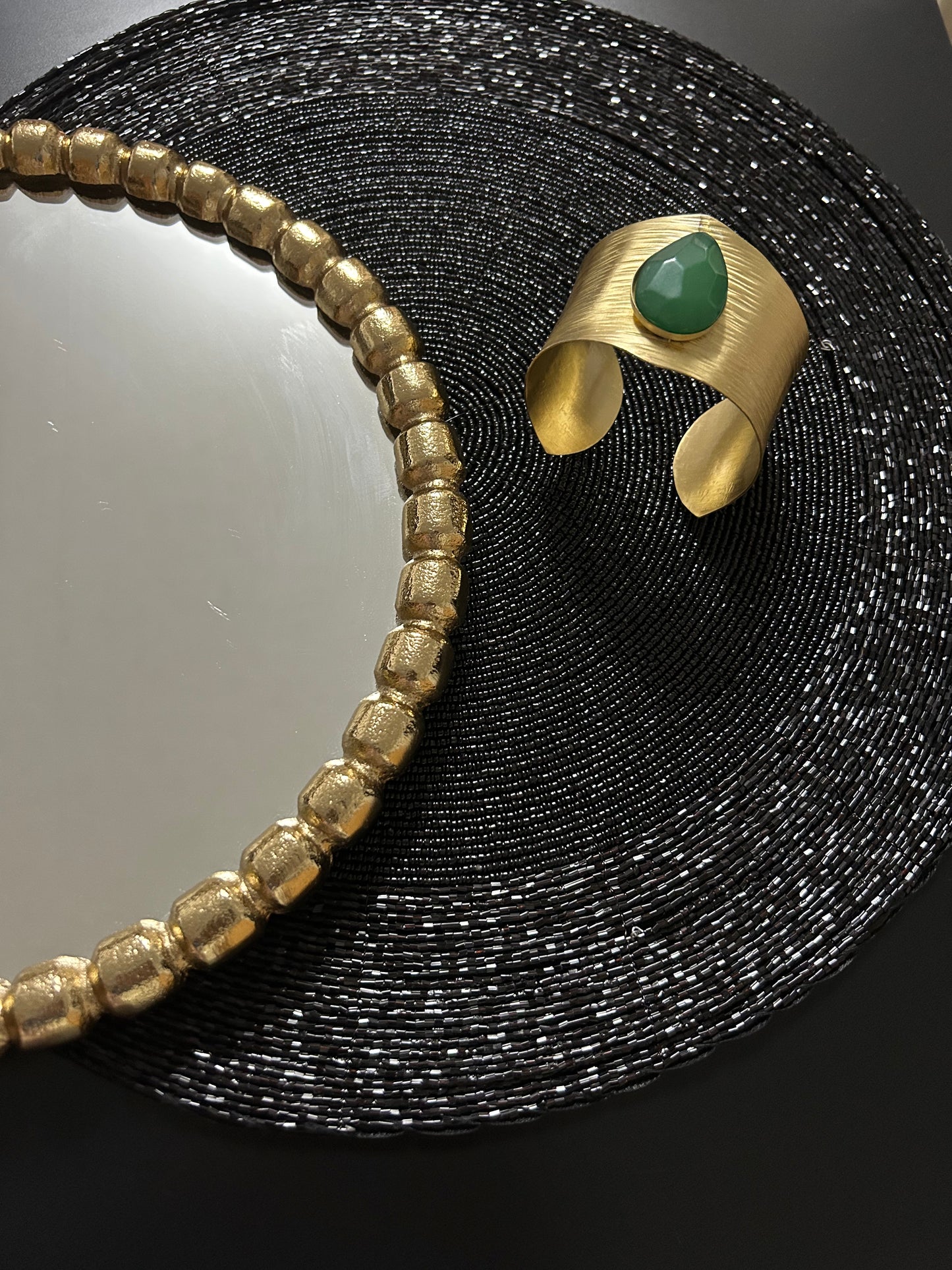 Brass bracelet with green faux stones