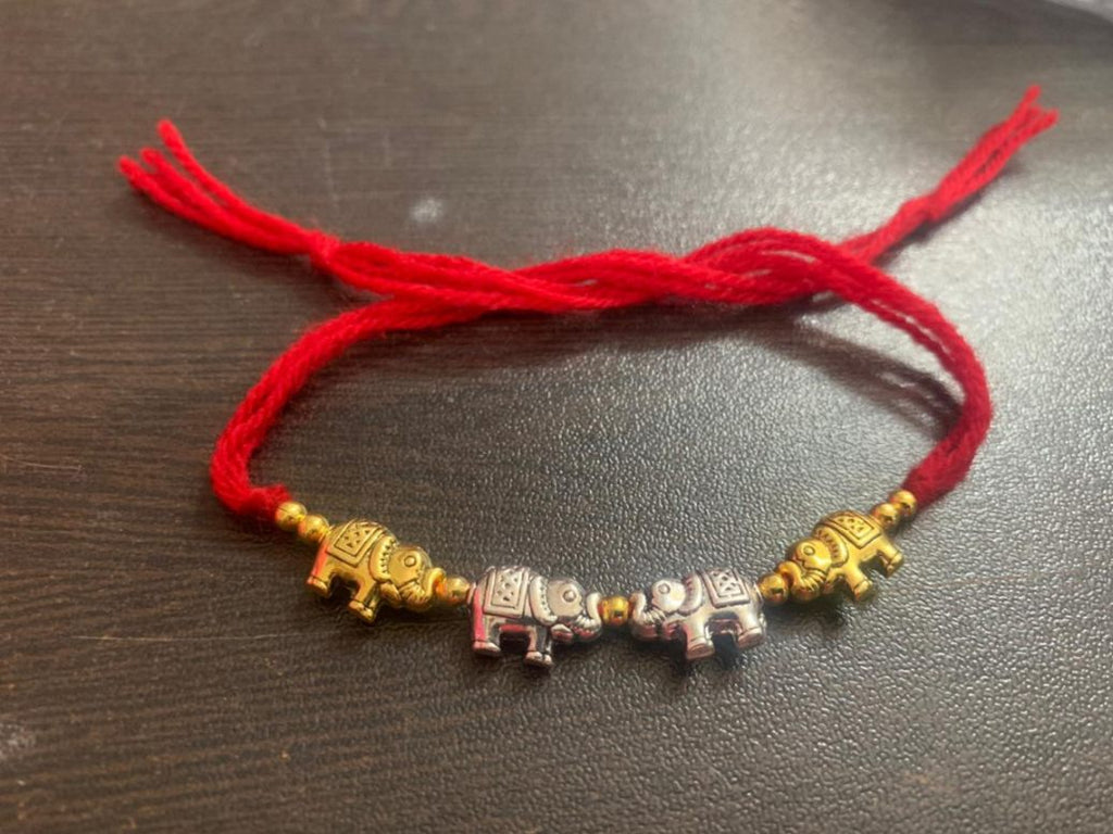 Rakhi - handmade, elephant beads, silver and gold colour