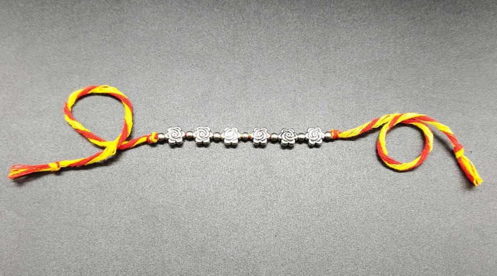 Rakhi - handmade, rose beads, silver colour