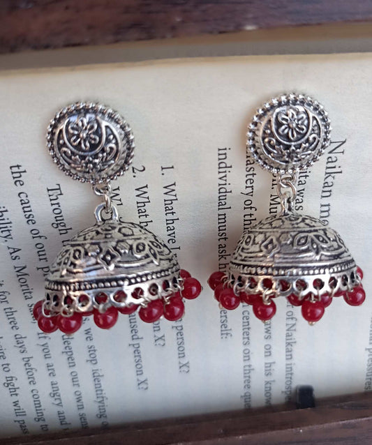 Oxidized Jhumki in silver colour with coin stud and red beads