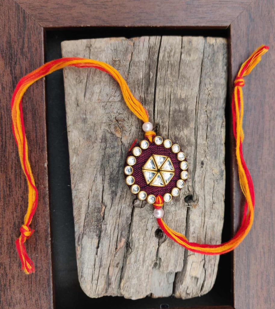 Rakhi - handmade, fabric and meenakari work, round shaped, maroon colour