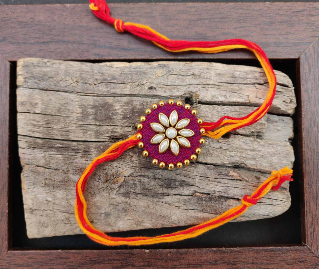 Rakhi - handmade, fabric and meenakari work, round shaped, maroon colour