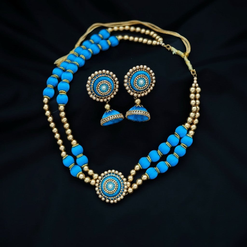 Gapochi choker necklace and jhumka earring set featuring light blue and gold round beads on a black background