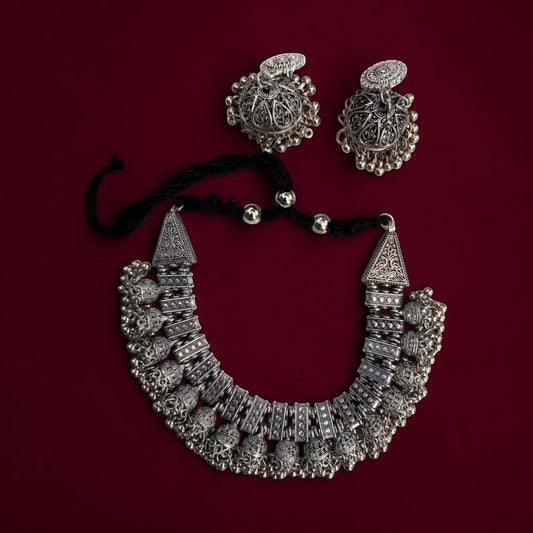 Gapochi oxidised silver tribal jhumki choker necklace and matching earrings with intricate filigree and bead details.